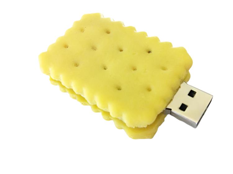 A USB flash drive designed to look like a peanut butter cracker or sandwich cookie, with a yellow color and textured surface resembling a biscuit.