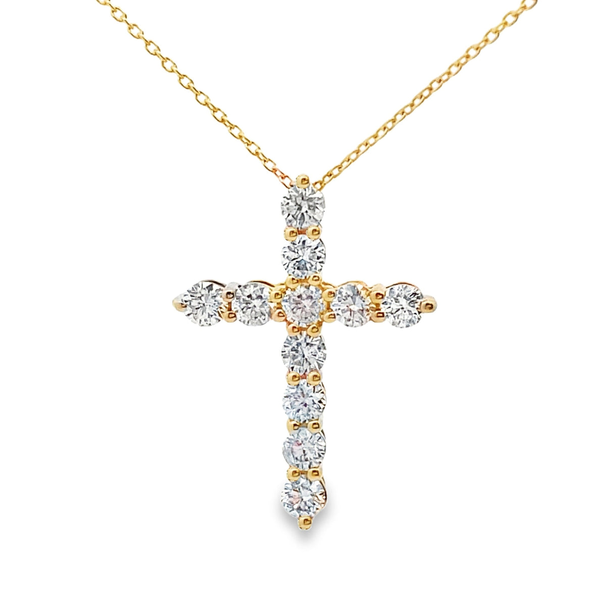 Colgante religioso de cruz con diamantes de .56ct en oro amarillo de 14kt